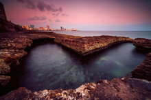 Heart Shaped Coastal Rock Pool At Sunrise With Cityscape In The Distance, Havana, La Habana, Cuba