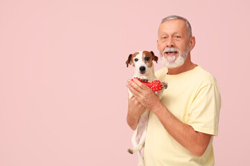 Sticker - Senior man with cute dog and toy on pink background