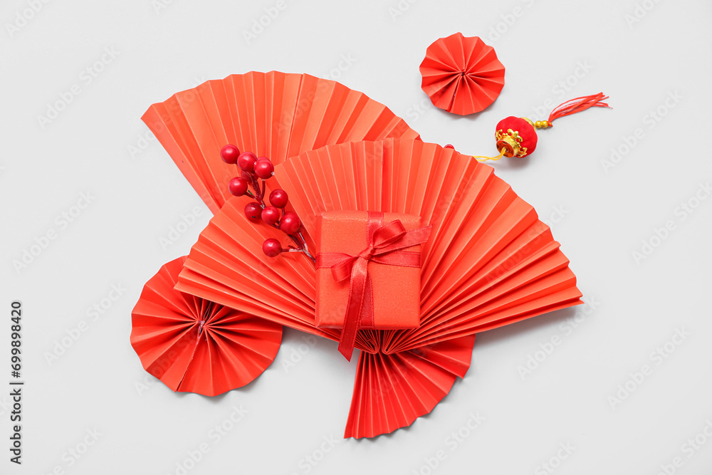 Gift box with berries and Chinese symbols on white background. New Year celebration