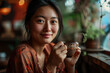 © 361 Portrait Studio - Beautiful Happy asian young woman drinking a cup of coffee sitting on sofa in living room at home