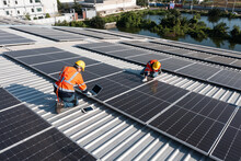 Two Caucasian Engineering Technician Is A Professional Trained In Skills And Techniques Installing Solar Photovoltaic Panels System On Industrial Factory Roof, Engineering Concepts To Good Environment
