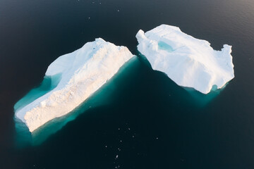 Wall Mural - Melting icebergs by the coast of Greenland, on a beautiful summer day - Melting of a iceberg and pouring water into the sea. Global warming
Arctic nature landscape, Summer day