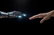 © Varun - The human finger delicately touches the finger of a robot's metallic finger. Concept of harmonious coexistence of humans and AI technology