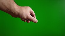A Man Shows The "salt" Gesture With His Fingers On A Green Background