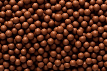 Wall Mural - Top view of chocolate corn balls, serving as breakfast cereal, with a textured background of cereal balls.