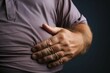 © Jawed Gfx - Obesity awareness a mans hand showcases excess belly fat