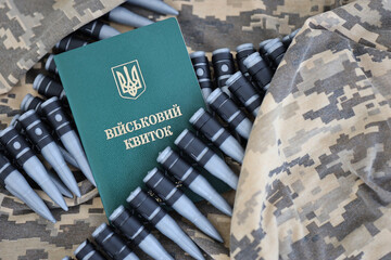 Wall Mural - Ukrainian military ID on fabric with texture of pixeled camouflage. Cloth with camo pattern in grey, brown and green pixel shapes with Ukrainian army personal token and machine gun belt of bullets