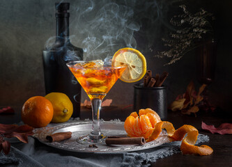 Wall Mural - Citrus drink with ice, tangerines and spices on a dark background