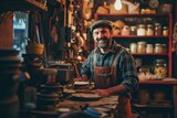 Fototapeta Londyn - Portrait of happy man seller who is standing on his workplace in shop, 