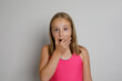 © millaf - Surprise. Pretty young girl portrait. Little kid posing on light gray studio background