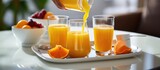 Fresh juices being poured at hotel breakfast table in the morning.