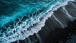 crisp blue ocean waves meeting black volcanic sand, aerial perspective