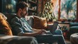 © ckybe - A youthful man unwinds on a sofa, savoring a quiet and peaceful moment at home with his laptop.