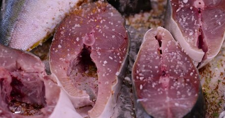 Wall Mural - pieces of sea fish during cooking, raw yellow-tailed fish during cutting for cooking