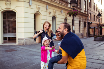 Caucasian family with black son having fun in the city