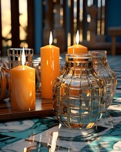 Candles in a glass vase on a table with a blurred background