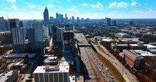 Multiple Cars Travel By The Wide Multi-lane Roads Of Atlanta, Georgia, USA. Sunny Cityscape Of Busy Metropolis From Top View.