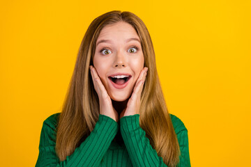 Sticker - Photo of cheerful impressed girl arms touch cheekbones open mouth empty space isolated on yellow color background