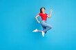 Photo of sporty optimistic girl dressed trendy outfit advertising clothes collection isolated on blue color background
