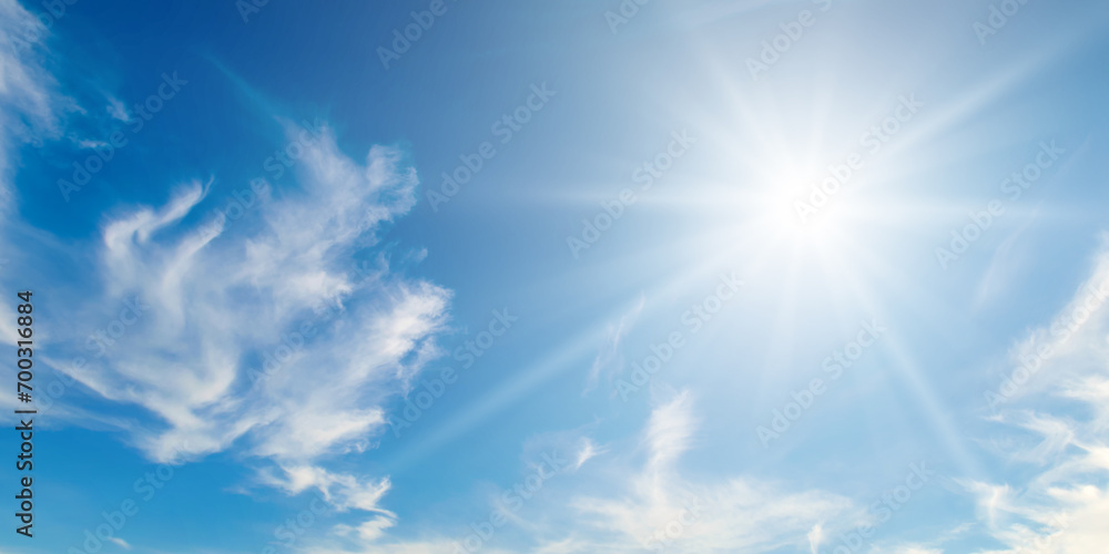 Cumulus clouds and bright sun in the sky. Wide photo. Stock Photo ...