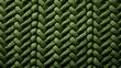  a close up view of a green knitted fabric with a diamond pattern in the middle of the knitting stitch.