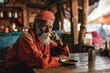 Portrait of an aged Indian man dressed in traditional clothes, relaxing at a restaurant table, showcasing cultural richness and leisure