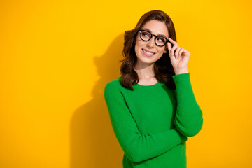 Poster - Portrait of minded creative girl arm touch glasses look empty space contemplate isolated on yellow color background