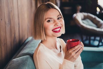 Sticker - Profile portrait of stunning positive person beaming smile sit comfy couch hold coffee mug loft interior flat inside