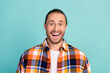 Photo of impressed overjoyed man with beard dressed flannel checkered shirt staring at unbelievable sale isolated on teal color background