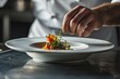 © Simon - A chef preparing a delicious dish in a fine restaurant.