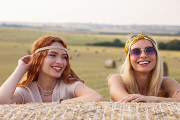 Canvas Print - Portrait of beautiful happy hippie women in field