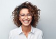 © kilimanjaro  - Smiling curly woman wearing glasses on Grey background.
