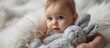 © HN Works - Baby on white fur hugging his plush rabbit. Creative Banner. Copyspace image