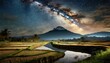 mountain and rive field with river in the middle at night time, beautiful view of rice field at night time with miky way view above the mountain