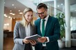 © yj - two male and female businessmen looking at digital tablet in company lobby, in the style of joyful, light gray and dark emerald, urban. generative AI