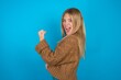 © Jihan - Profile side view portrait beautiful caucasian teen girl wearing brown sweater celebrates victory