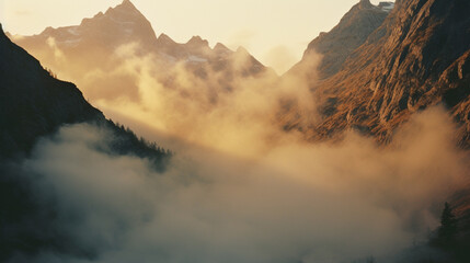 Poster - A majestic graphic landscape of rugged mountains, their peaks shrouded in mist as the morning sun casts a warm glow on the towering slopes.