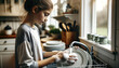 Young teenage girl washing dishes at home. Helping out with household chores can boost self-esteem, teach responsibility, and help your child feel like he's part of the home