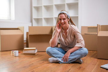 Wall Mural - Modern ginger woman with braids moving into new apartment.	