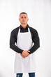 © theartofphoto - Attractive chef or waiter posing, wearing white apron and black shirt isolated on white background, in studio shot