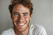 portrait of a confident young man with red hair an freckles