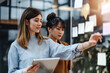 © Nedrofly - Two Women Looking at Sticky Notes on a Glass Wall
