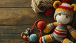 Colorful knitted toy with yarn balls on a wooden surface