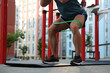 © New Africa - Muscular man doing exercise with elastic resistance band on mat at sports ground, closeup
