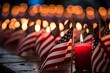 An American flag gently draping over a row of memorial candles on Patriot Day