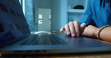 Time lapse male hand working on laptop. Man works on laptop flips through internet online web pages social networks uses touchpad to control laptop. Close up male guy's hands keyboard computer screen