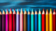 Spectrum of Colored Pencils Lined Neatly on a Textured Blue Wooden Artistic Background