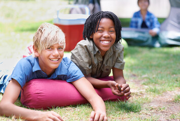 Wall Mural - Camping, children and relaxing in portrait on outdoor adventure, bonding and happy outside. Kids, face and smiling together on holiday, friendship and vacation in nature, park and grass on ground