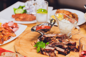 Wall Mural - Dining table with a variety of snacks and salads. Salmon, olives, wine, vegetables, grilled fish toast. The concept of a family celebratory dinner. Thanksgiving, Christmas. top veiw.