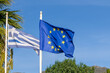 View the Greek national flag and the flag of the European community